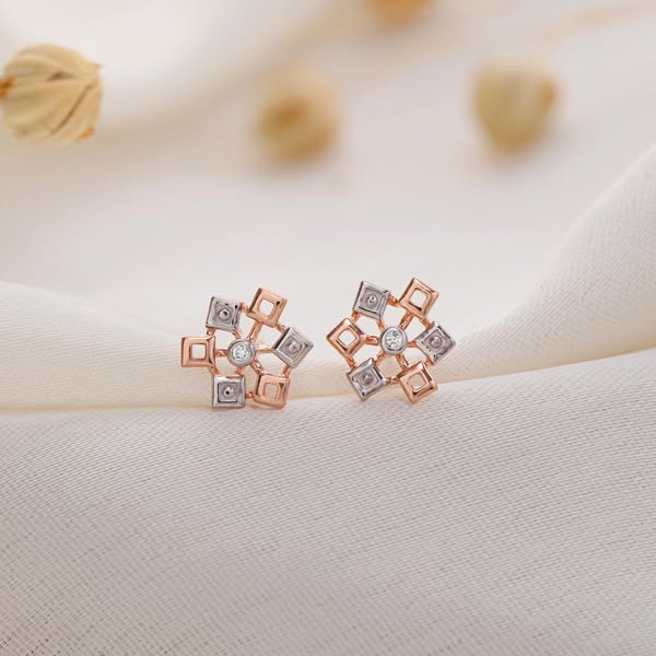 This ad showcases a pair of earrings with a geometric design, featuring a rose gold and silver color scheme and a centra