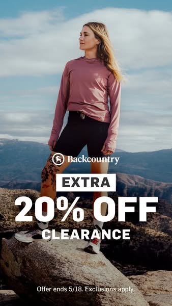 This image ad promotes Backcountry's clearance sale, offering an extra 20% off. It features a woman standing on a ro