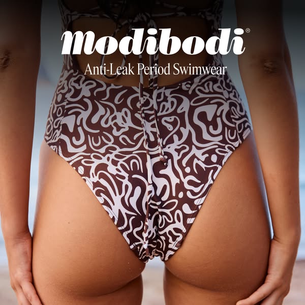 This image ad showcases a woman wearing a Modibodi Anti-Leak Period Swimwear swimsuit with a brown and white pattern. Th