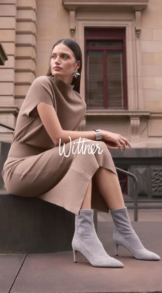 An image ad featuring a woman wearing the brand's dress and boots, with the brand logo.