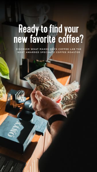 This image ad promotes Onyx Coffee Lab, highlighting its award-winning specialty coffee. It features a hand holding a ba