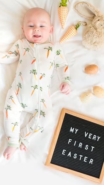 This image ad features a baby lying on a white blanket next to Easter-themed props. The ad is likely intended to appeal 