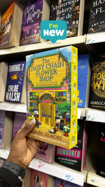 This image ad promotes "The Daisy Chain Flower Shop" by Laurie Gilmore, presented as a new book arrival in wha