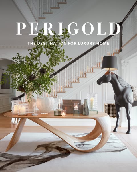 A hero shot of an interior showcases a luxurious home decor collection from Perigold. The image is staged in a grand foy