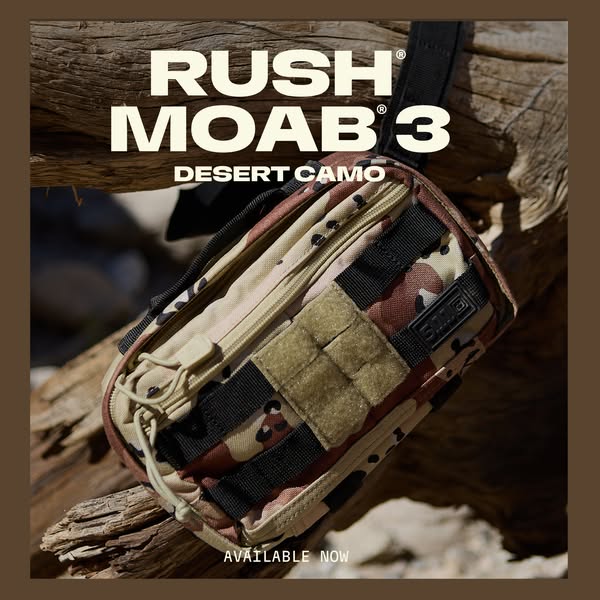 This ad features the Rush MOAB 3 bag in desert camo. The bag is displayed on a log and is available now.