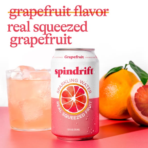 A can of Spindrift sparkling water is featured alongside a glass of the beverage and whole and sliced grapefruits. The t