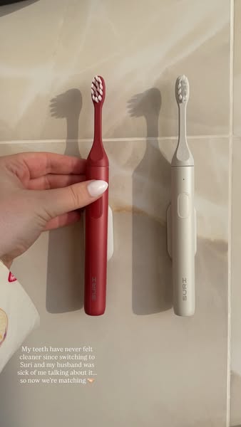 A user shares their experience switching to SURI toothbrushes, noting improved cleanliness and their husband's enthu