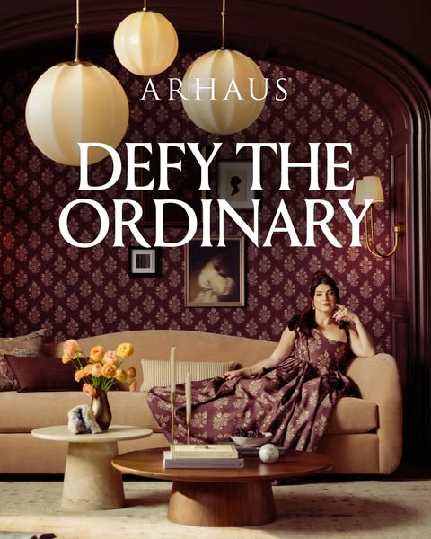 This ad features an image of a woman in a patterned dress lounging on a couch in a stylized living room with the text &#