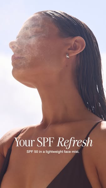 This ad shows a woman outside in natural light, applying a lightweight SPF 50 face mist to her face.