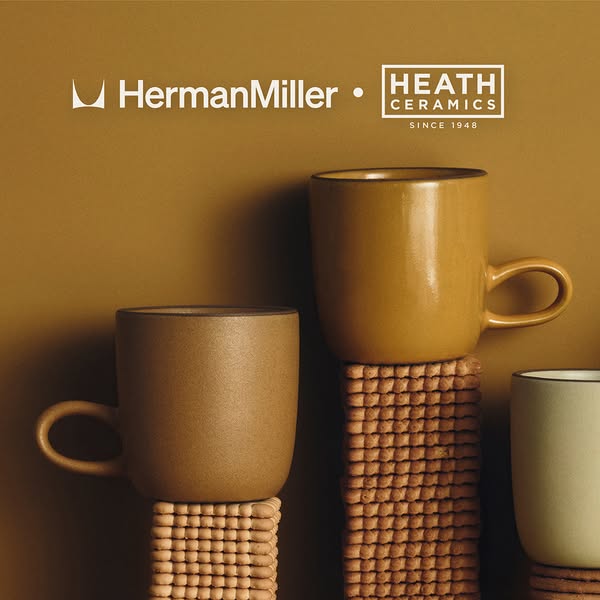 The ad showcases a collaboration between Herman Miller and Heath Ceramics, highlighting their co-branded ceramic mugs. T