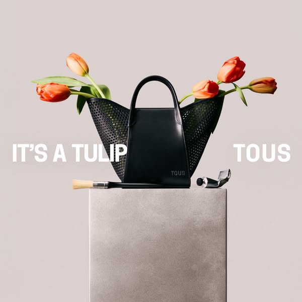 This image ad for TOUS features a black purse alongside art supplies and tulips, suggesting that the purse is a stylish