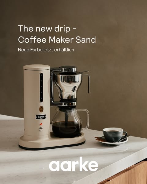 This image ad showcases the new sand color of the Aarke coffee maker. The visual aesthetic is clean and modern, highligh