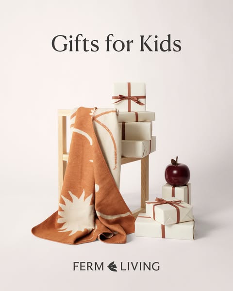 This still image ad from Ferm Living showcases a selection of gift options for kids, including a blanket with a sun desi