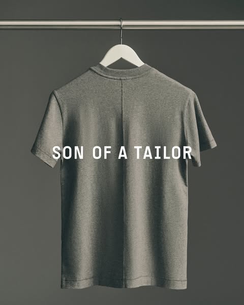 This is a simple image ad that showcases a gray Son of a Tailor t-shirt hanging on a hanger against a gray background. T