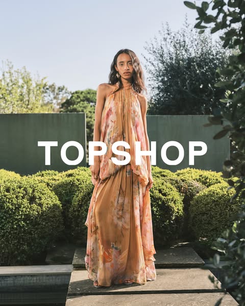 This ad features a woman in a long, flowing, floral dress from Topshop, set in a sunlit outdoor setting.