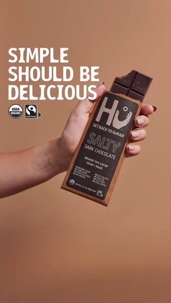 The ad showcases Hu Salty Dark Chocolate, emphasizing its simple, organic ingredients and delicious taste. The image fea
