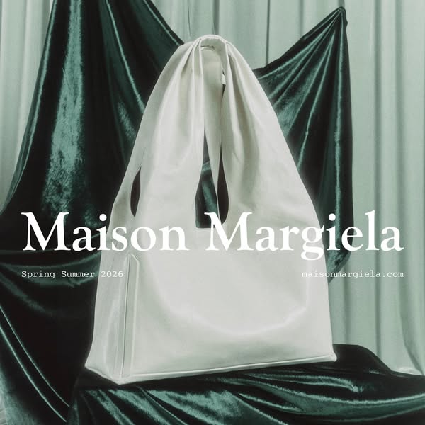 This ad features a simple studio shot of a white bag, with the brand name and website URL.