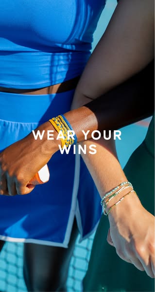 The ad features two women in tennis outfits wearing colorful bracelets, and is promoting accessories to 'wear your w