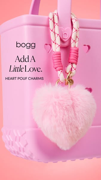 This ad showcases a pink Bogg Bag with a heart pouf charm. The bag is a light pink color and is made of a durable, water
