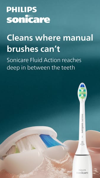 The ad showcases a Philips Sonicare electric toothbrush and highlights its ability to clean in areas manual toothbrushes