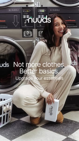 This ad features a woman in loungewear crouching in a laundromat, promoting Nuuds brand essentials as an upgrade from re