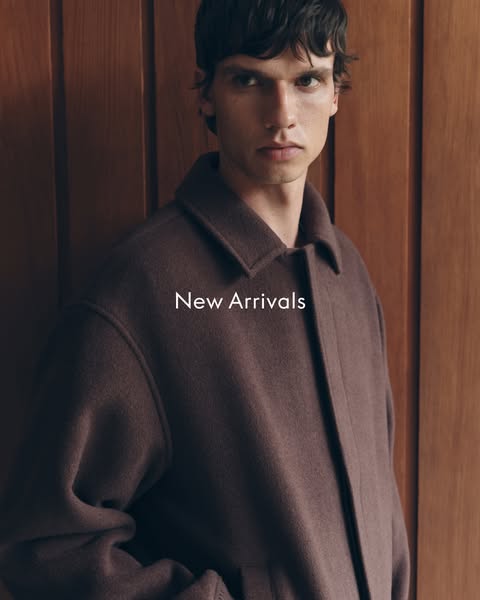 This image showcases a new arrival of a brown, wool coat on a male model.