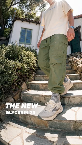 A person is walking down stone stairs outside on a sunny day wearing the Brooks Glycerin 23 shoe.