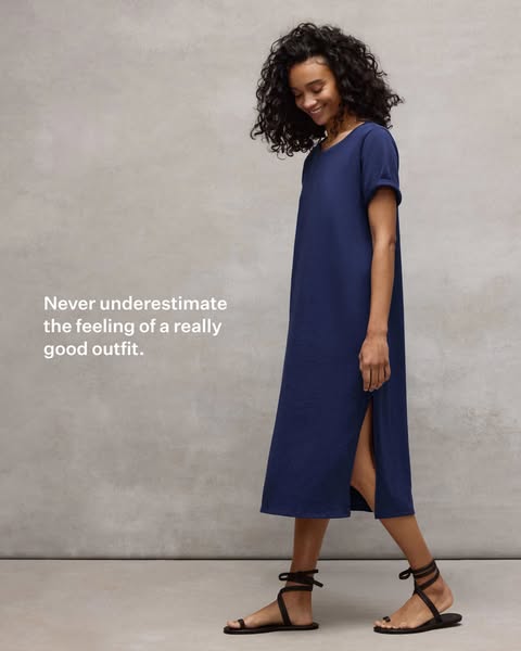This ad for a navy blue dress features a woman wearing the dress and a caption that reads, "Never underestimate the