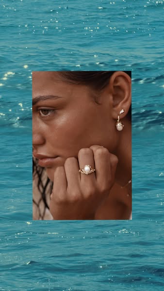 This ad features a close-up shot of a woman showcasing jewelry (a ring and earrings). The image is cropped to show the j