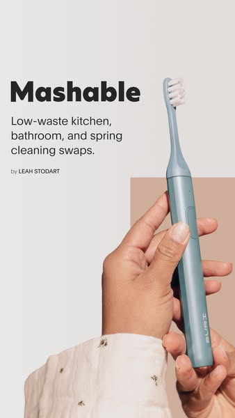 This ad features a blue SURI toothbrush being held in someone's hand. The headline is a quote from Mashable calling 