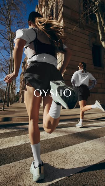 This ad features two women running through a city in workout apparel and shoes from Oysho. The focus of the shot is on t