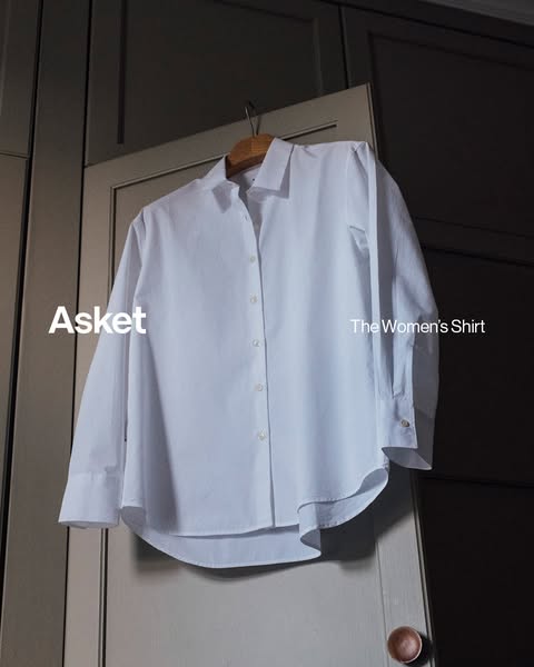 This ad showcases a white women's shirt from Asket, emphasizing its classic design and quality.