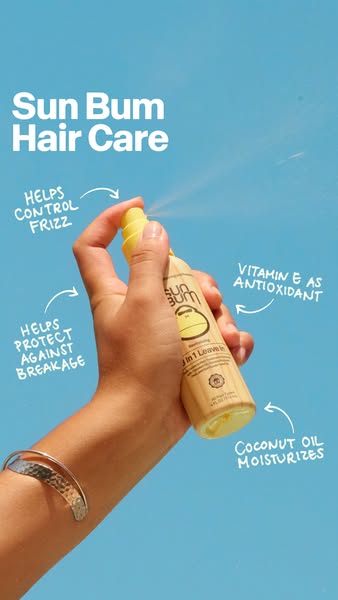 This image ad for Sun Bum Hair Care features a hand spraying the product with arrows pointing to product benefits and ke