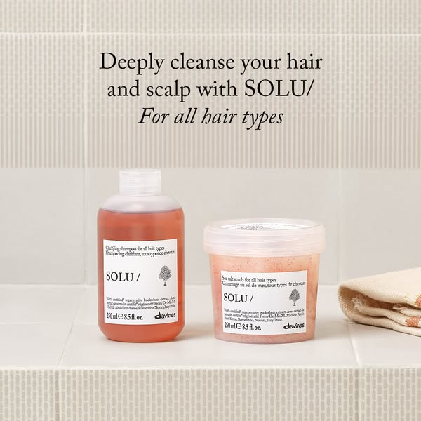 Image ad for Davines SOLU/ clarifying shampoo and sea salt scrub. The headline states that the products deeply cleanse t