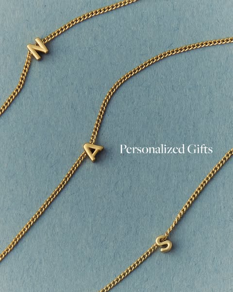 This ad promotes personalized gifts, specifically necklaces with letter pendants on a gold chain.