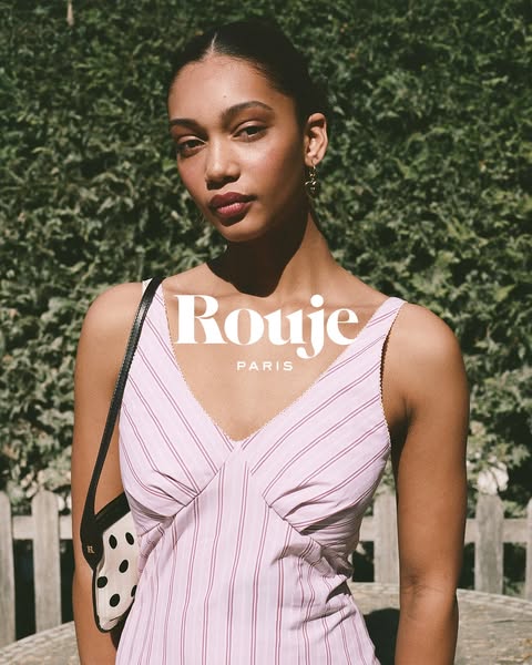 This is a lifestyle ad for the brand Rouge Paris that shows a woman wearing a dress and purse from the brand. The ad has