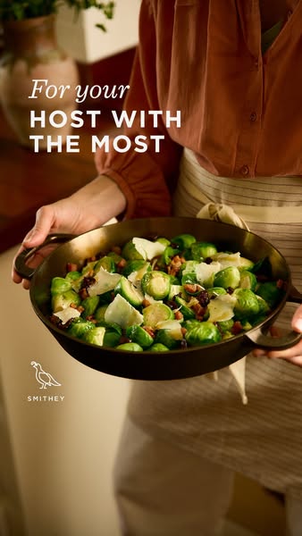 This image ad is promoting Smithey cookware. The ad features a person holding a skillet full of cooked brussel sprouts.
