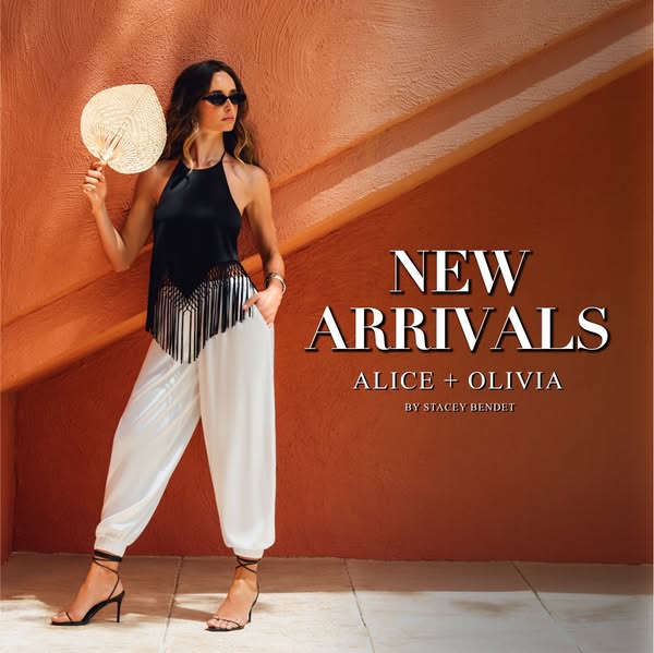 This image ad promotes Alice + Olivia apparel. It features a model in a black halter top and white pants, standing again
