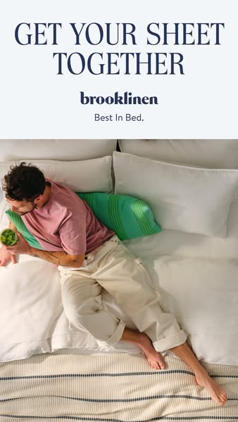An overhead shot of a man lounging in bed with an eye-level view of the product. The ad sells Brooklinen sheets.