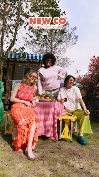 An image ad showcasing three women in an outdoor setting, likely a backyard or camping ground, gathered around a makeshi
