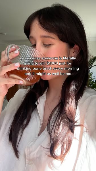 This image ad features a woman drinking bone broth and discussing a contest where someone will win $1000 for drinking it