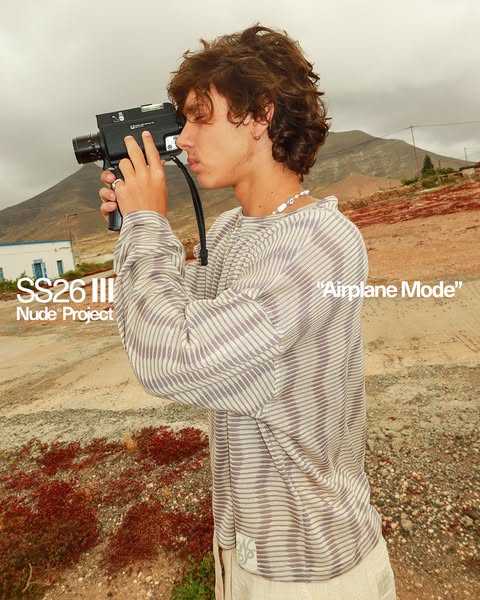 An ad for Nude Project featuring a model filming in a scenic outdoor location with a retro camera, highlighting their cl