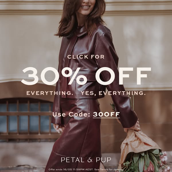 This is an image ad for Petal & Pup. It features a woman in a matching jacket and skirt of the same brown color whil