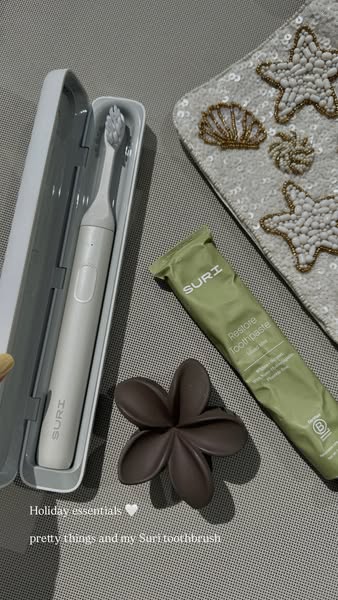 This ad showcases a Suri toothbrush and toothpaste, portraying them as holiday essentials alongside luxurious decorative