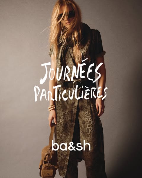 This ba&sh image ad features a woman wearing a printed wrap dress and carrying a small brown bag. The ad promotes th