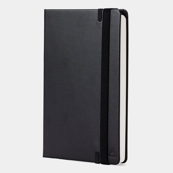 This ad features a sleek, minimalist notebook with a black cover and elastic closure, set against a neutral background. 