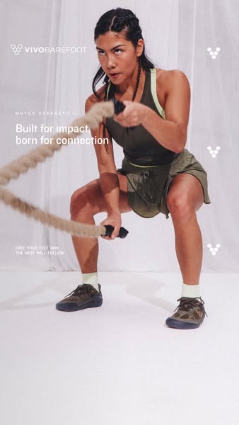 This image ad for Vivobarefoot shoes features a woman doing a workout. She is holding the ropes, squatting with her feet