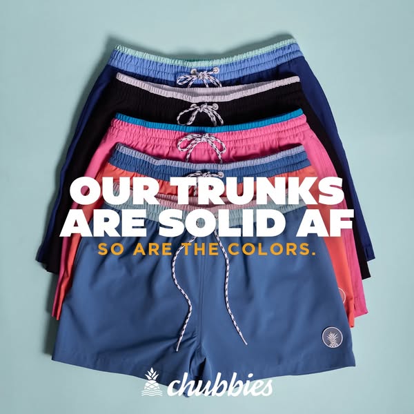 This image ad for Chubbies displays a stack of their solid-colored trunk shorts against a light blue background. Bold te