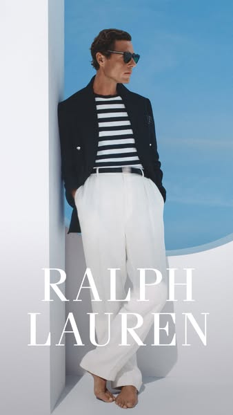 A man is leaning against a wall wearing clothing from Ralph Lauren. The brand name is also displayed in large letters on