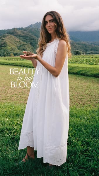 This ad features a woman in a white dress in a field holding a small object in her hand. The ad highlights the concept o